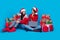 Full length photo of cute excited women santa elves wear ornament pullovers ordering gadget x-mas gifts isolated blue