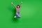 Full length photo excited lucky young lady dressed colorful pullover jumping high rising arms isolated green color