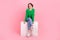 Full length photo of funky adorable girl dressed green sweater smiling sitting platform isolated pink color background