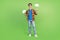 Full length photo of funky brunet young guy hold look clouds wear shirt jeans sneakers isolated on green background