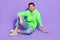 Full length photo of funny charming guy dressed neon sweatshirt smiling having rest isolated violet color background