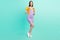 Full length photo of happy charming positive woman wear purple dress isolated on teal color background