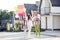 Full length photo of happy family daddy mommy child positive smile wear party hat celebrate enjoy walk outdoors harmony