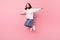 Full length photo of happy nice young woman jump up hands fly wings plane isolated on pink color background