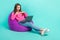 Full length photo of impressed excited girl wear pink sweater reading news device empty space isolated turquoise color