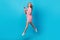 Full length photo of intelligent nice woman with curly hairdo wear pink dress flying hold smartphone isolated on blue