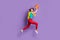 Full length photo of lady jump run throw ball wear tied sweater t-shirt pants footwear isolated violet color background