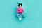 Full length photo of lovely girlish woman fluttering hair wear pink sweater jeans jumping folded palms isolated on teal