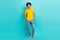Full length photo placard of young positive guy wear yellow t-shirt denim jeans hands pockets model brand clothes