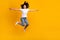 Full length photo of positive carefree woman wear white t-shirt jumping arms sides empty space isolated yellow color