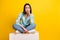 Full length photo of pretty lovely adorable girl wear blue cardigan looking upset sitting on cube  on yellow