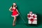 Full length photo of pretty lovely fancy dreamy girl in santa claus headwear enjoy deliver sledge pile stack x-mas gift