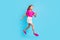Full length photo of pretty nice happy girl jump up run empty space hurry sale isolated on pastel blue color background