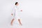 Full length photo of pretty sweet young lady physician dressed uniform walking looking empty space isolated white color