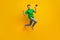 Full length photo of satisfied ecstatic man jumping holding loudspeaker shout yeah win lottery isolated on yellow color