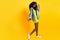 Full length photo of shiny cute dark skin lady dressed denim outfit glasses dancing empty space isolated yellow color