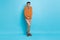 Full length photo of shy embarrassed young man hold hands together wear glasses nerd isolated on blue color background
