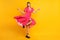 Full length photo of stunning attractive happy young woman raise hands skirt dress fly isolated on yellow color