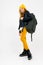 Full-length photo of stylish teenager girl in a white shirt, unbuttoned leather black jacket, yellow trousers and a