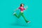 Full length photo of sweet impressed schoolgirl wear pink crop top flare trousers jumping high isolated turquoise color