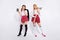 Full length photo of two cruel ladies ready for helloween party wear costumes  white background