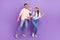 Full length photo of two overjoyed crazy partners listen music dancing isolated on violet color background