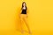 Full length photo of young attractive woman happy positive smile confident hands in pocket isolated over yellow color