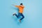 Full length photo of young excited man jump up dab hip-hop dance active energetic isolated over blue color background