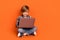 Full length photo of young handsome boy type email homework laptop isolated over orange color background