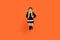 Full length photo of young school girl unhappy moody offended jump up hold bag isolated over orange color background