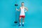 Full length photo of young skinny man happy positive proud exercise weightlifting isolated over blue color background