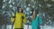 Full length portrait of active young couple enjoying skiing in snowy winter forest, focus on smiling woman in front