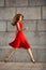 Full length portrait of attractive elegant young woman in red dress