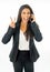 Full length portrait of Attractive latin corporate latin woman talking on smart phone and making victory sign in Creative success