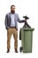 Full length portrait of a bearded man throwing a bin bag in a dustbin