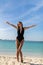 Full length portrait of beautiful happy woman standing in sea, swimming. Young happy cheerful woman in bikini smiling, enjoying