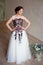 Full-length portrait of Beautiful luxurious female model with medium brown hair in a long fashinable dress standing in