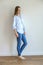 Full length portrait of a beautiful young woman in jeans and a blue shirt. Body positive. lucky person