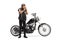 Full length portrait of a biker with a chopper putting on a helmet