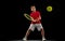 Full-length portrait of boy, training tennis isolated over black background