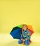 A full length portrait of a bright fashionable girl in a raincoat
