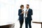 Full-length portrait of business partners, colleagues during a coffee break. Boss and employee flirting at work. The concept of