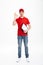 Full length portrait of caucasian deliveryman in red t-shirt and