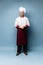 Full length portrait of cheerful joyful chef cook with stubble in beret and white outfit looking at camera isolated