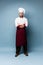 Full length portrait of cheerful joyful chef cook with stubble in beret and white outfit looking at camera isolated