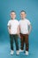 Full length portrait of cute twin brothers