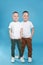 Full length portrait of cute twin brothers