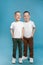 Full length portrait of cute twin brothers