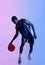 Full length portrait of determined black basketballer playing ball in neon lighting