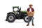 Full length portrait of a farmer with a crate full of fresh apples standing in front of a tractor